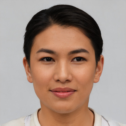 Joyful asian young-adult female with short  black hair and brown eyes