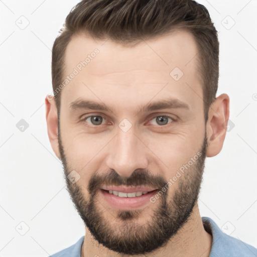 Joyful white young-adult male with short  brown hair and brown eyes