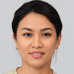 Joyful asian young-adult female with medium  brown hair and brown eyes