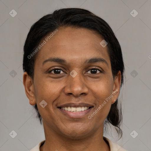 Joyful black adult female with medium  brown hair and brown eyes