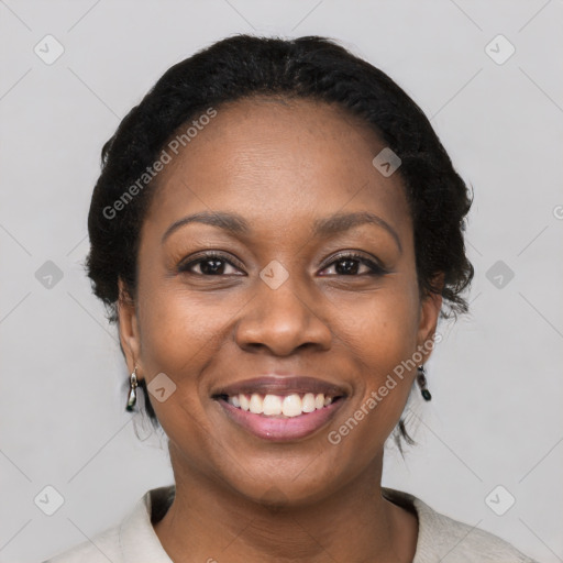 Joyful black young-adult female with short  black hair and brown eyes