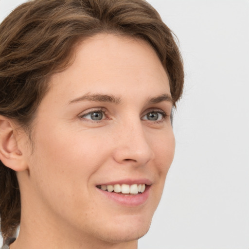 Joyful white young-adult female with medium  brown hair and green eyes