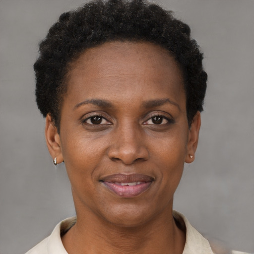 Joyful black adult female with short  brown hair and brown eyes