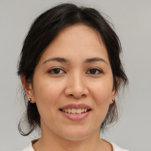 Joyful white young-adult female with medium  brown hair and brown eyes