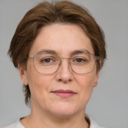 Joyful white adult female with medium  brown hair and grey eyes