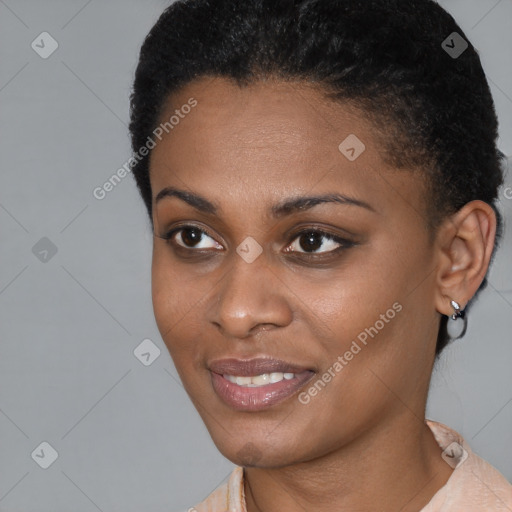 Joyful black young-adult female with short  black hair and brown eyes