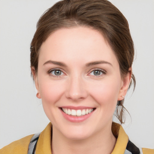 Joyful white young-adult female with medium  brown hair and blue eyes