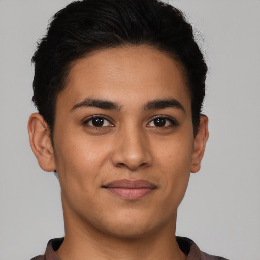 Joyful latino young-adult male with short  brown hair and brown eyes