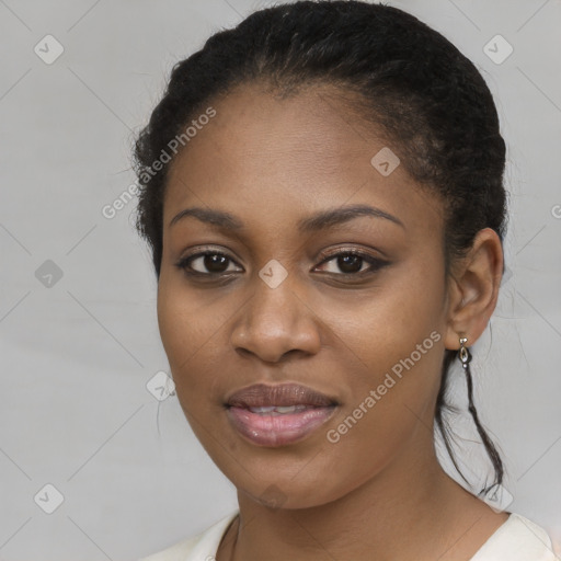 Joyful black young-adult female with long  brown hair and brown eyes