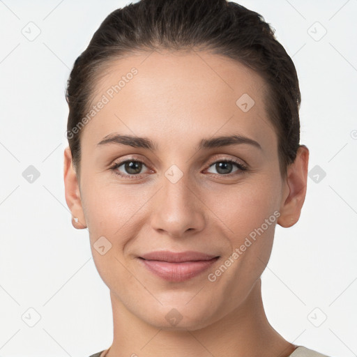 Joyful white young-adult female with short  brown hair and brown eyes