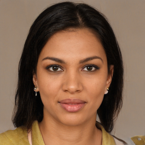 Joyful black young-adult female with medium  brown hair and brown eyes