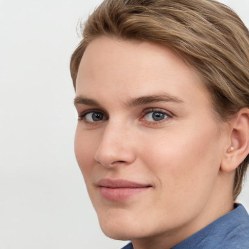 Joyful white young-adult female with medium  brown hair and blue eyes