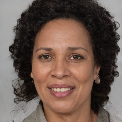 Joyful black adult female with medium  brown hair and brown eyes
