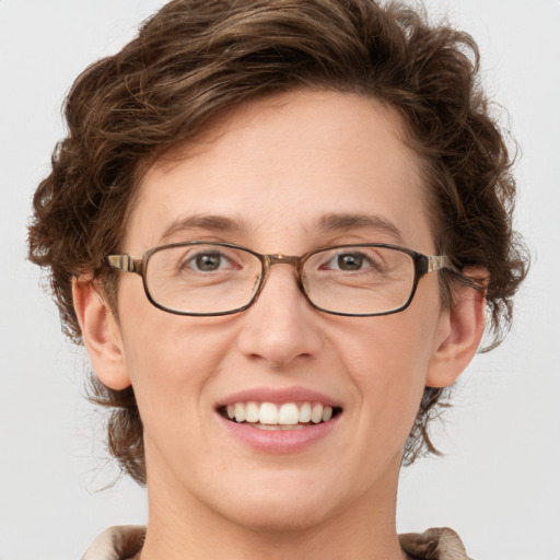 Joyful white adult female with medium  brown hair and green eyes