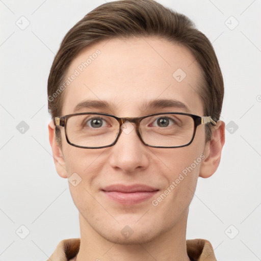 Joyful white young-adult male with short  brown hair and grey eyes