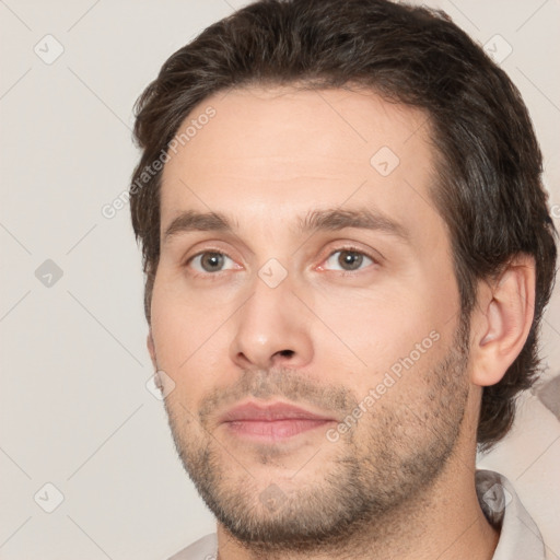 Joyful white adult male with short  brown hair and brown eyes