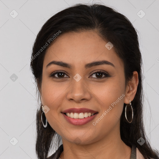 Joyful latino young-adult female with long  brown hair and brown eyes