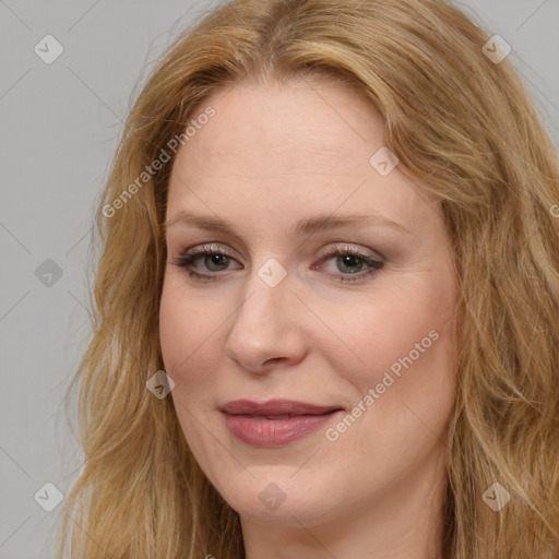 Joyful white adult female with long  brown hair and brown eyes