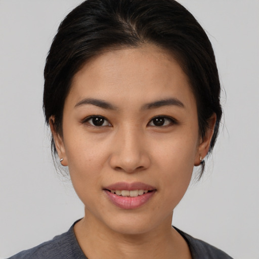 Joyful asian young-adult female with medium  black hair and brown eyes