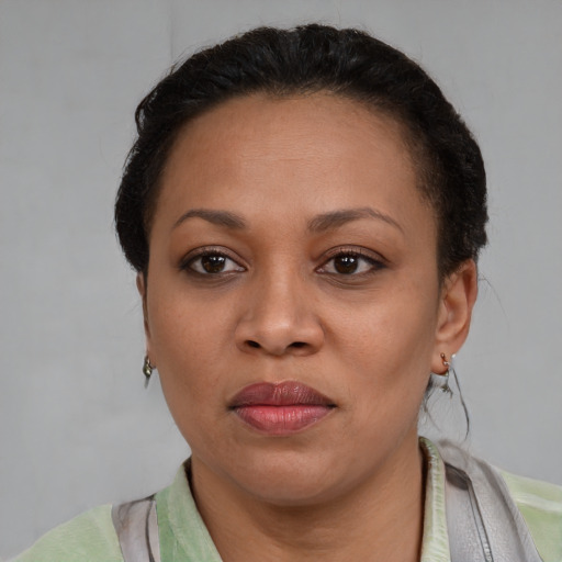 Joyful latino adult female with short  brown hair and brown eyes