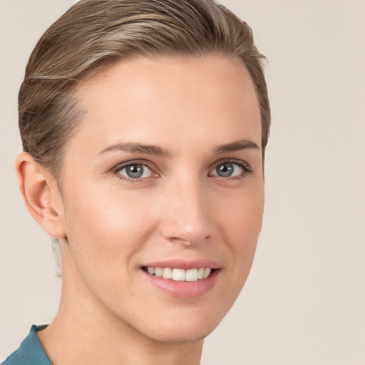 Joyful white young-adult female with medium  brown hair and grey eyes