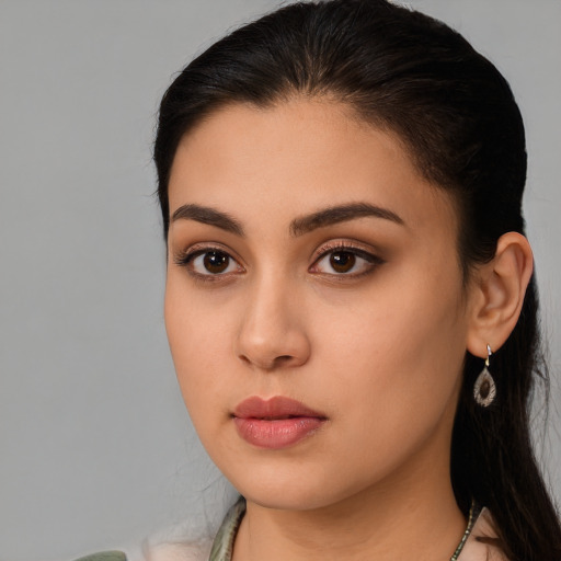 Neutral latino young-adult female with long  brown hair and brown eyes