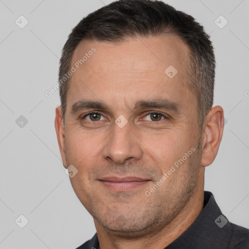 Joyful white adult male with short  brown hair and brown eyes