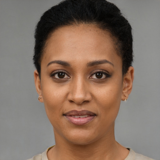 Joyful latino young-adult female with short  black hair and brown eyes