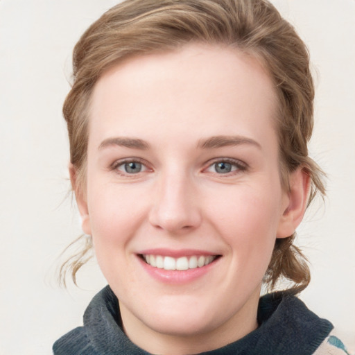 Joyful white young-adult female with medium  brown hair and blue eyes