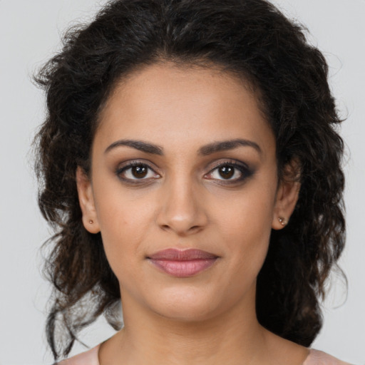 Joyful latino young-adult female with medium  brown hair and brown eyes