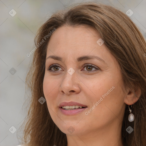 Joyful white adult female with long  brown hair and brown eyes