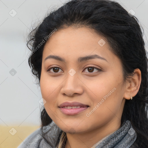 Joyful latino young-adult female with long  brown hair and brown eyes