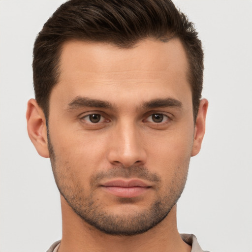 Joyful white young-adult male with short  brown hair and brown eyes