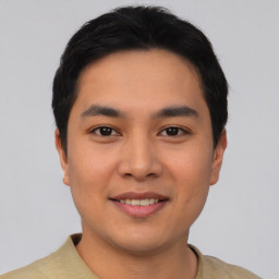 Joyful asian young-adult male with short  black hair and brown eyes