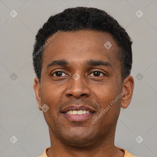 Joyful latino young-adult male with short  black hair and brown eyes