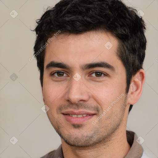 Joyful white young-adult male with short  black hair and brown eyes