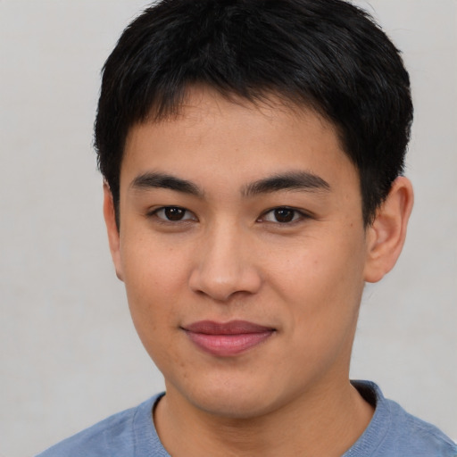 Joyful asian young-adult male with short  brown hair and brown eyes
