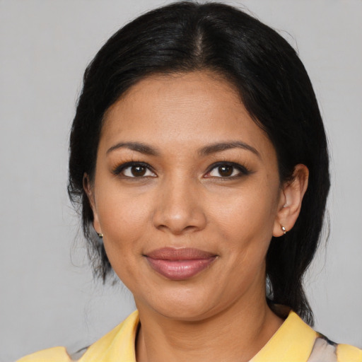 Joyful latino young-adult female with medium  black hair and brown eyes