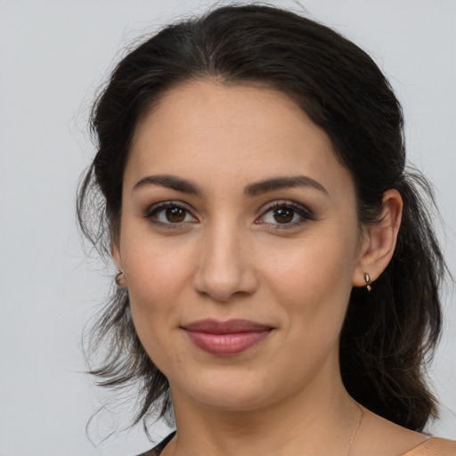 Joyful latino young-adult female with medium  brown hair and brown eyes