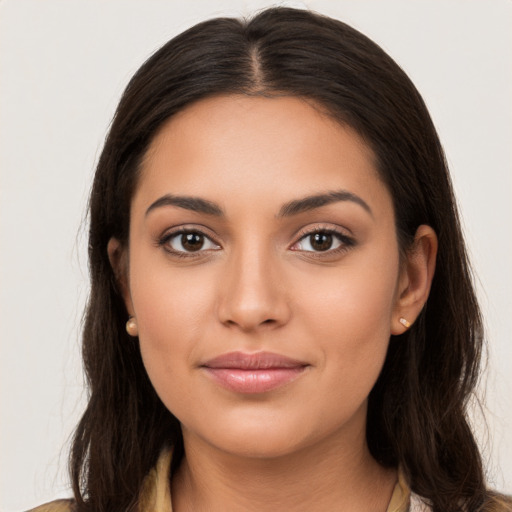 Joyful latino young-adult female with long  brown hair and brown eyes