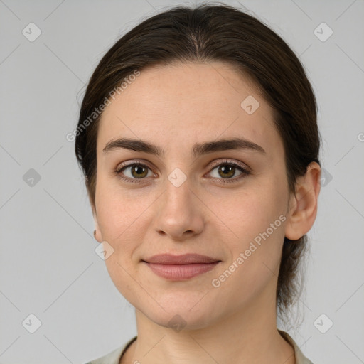 Joyful white young-adult female with medium  brown hair and grey eyes