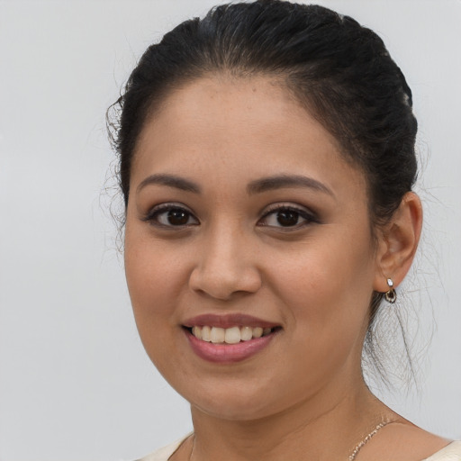 Joyful latino young-adult female with medium  brown hair and brown eyes