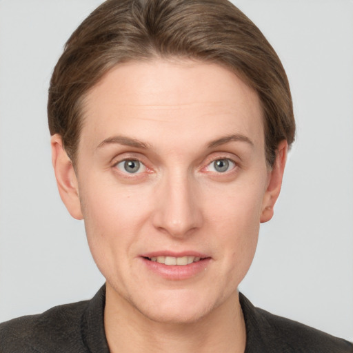 Joyful white young-adult female with short  brown hair and grey eyes