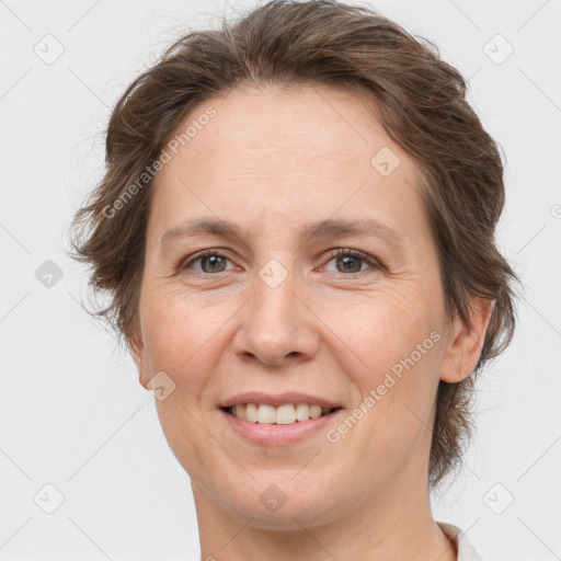 Joyful white adult female with short  brown hair and brown eyes