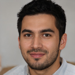 Joyful white young-adult male with short  black hair and brown eyes