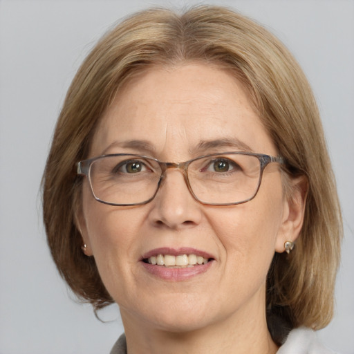 Joyful white middle-aged female with medium  brown hair and blue eyes