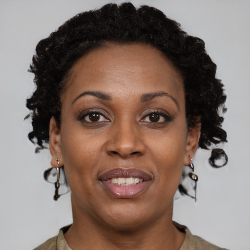 Joyful black adult female with short  brown hair and brown eyes
