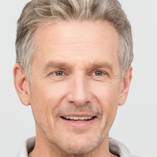 Joyful white middle-aged male with short  brown hair and grey eyes