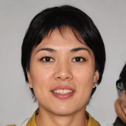 Joyful asian young-adult female with medium  black hair and brown eyes