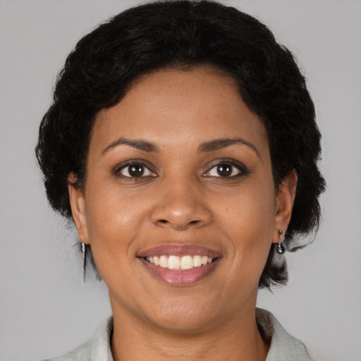 Joyful black young-adult female with short  brown hair and brown eyes